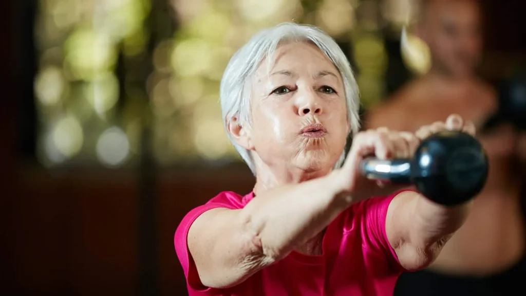 Toning Arms Without the Bulk: Is It Achievable? 1 Woman doing resistance band exercises for toned arms Doncaster